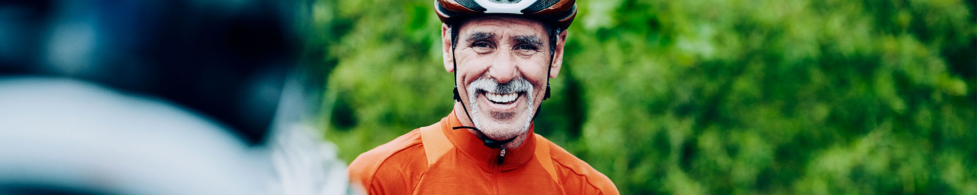 smiling man riding a bicycle